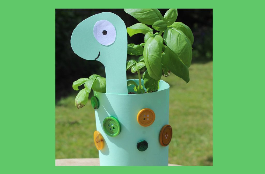 Craft activity to make a cardboard dinosaur plant pot. The dinosaur is decoracted with colourful buttons