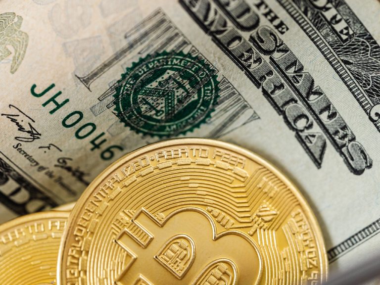 An image featuring a close up of dollar bills and gold bitcoins
