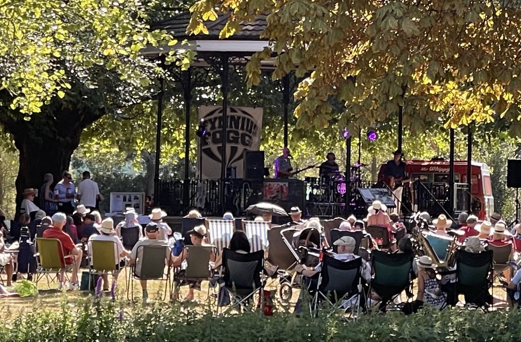 Fynnius Fogg playing at the bandstand in Bedford's Mill Meadows with the crowd sitting on stripy deckchairs