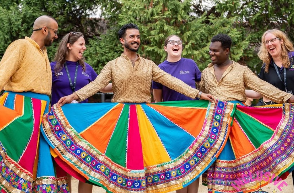 Members of the LGBTQ+ dance group BollyQueer with volunteers from the Inclusive Performing Arts Festival in the gardens of the Quarry Theatre. Image Inclusive Performing Arts Festival