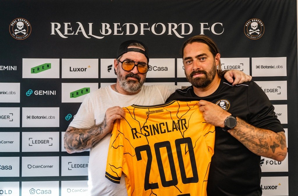 Real Bedford co-owner and Chairman, Peter McCormack (left) holding a commemorative shirt celebrating 200 games in charge for Rob Sinclair (right)