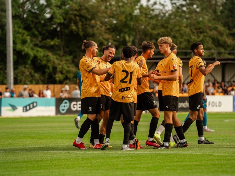 Real Bedford teammates celebrate a goal against Leamington at the Ledger Stadium