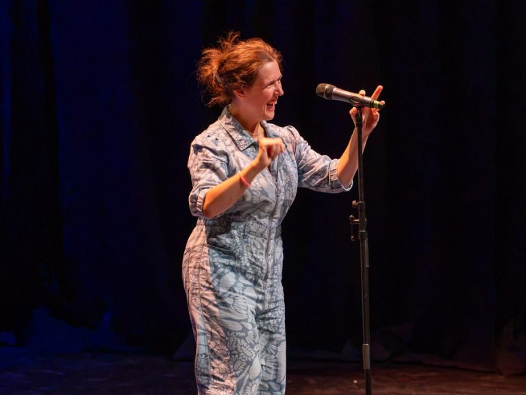 Rosie Jones on stage at the Quarry Theatre performing at the Party, Not Pity show. Image Inclusive Performing Arts Festival