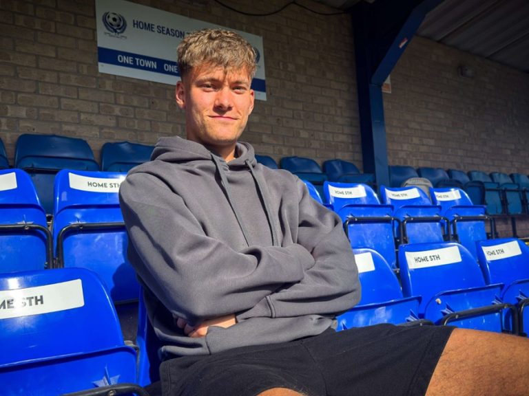 Bedford Town's Ryan Cole sitting in the stands at The Eyrie