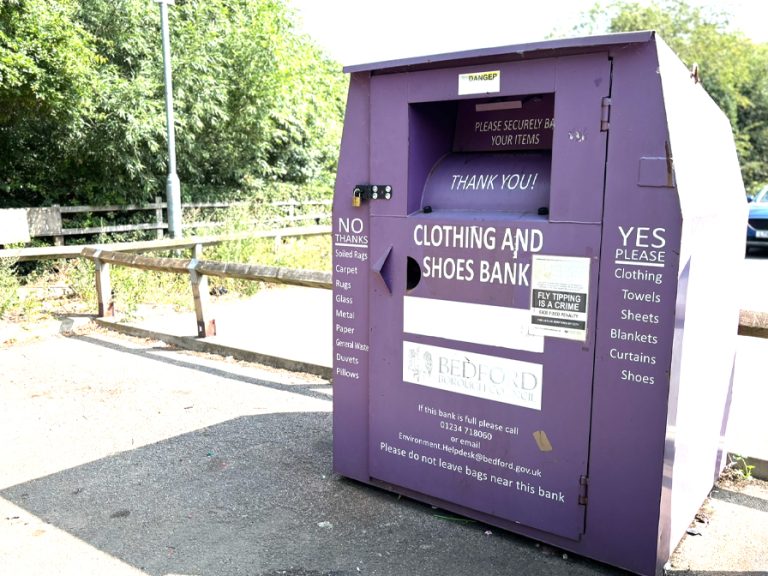 A purple textile and clothing recycling bank in a council car park in Bedford
