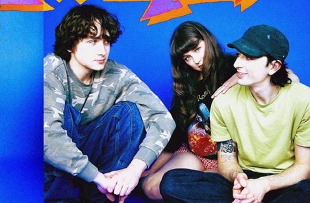 The three members of the band Golomb seated on the floor